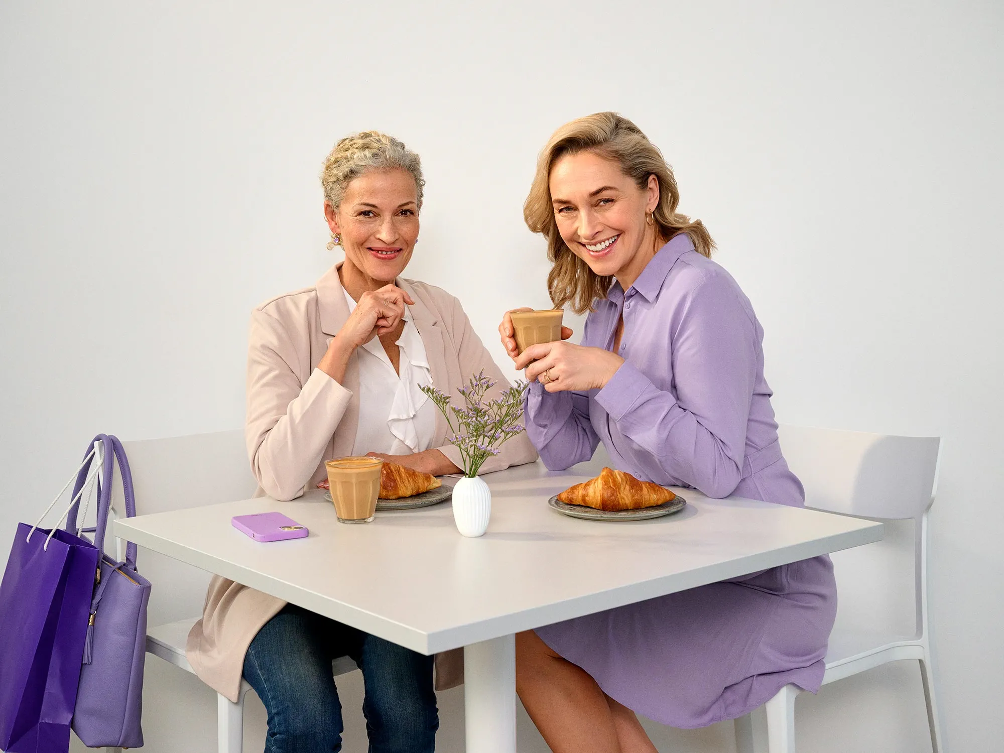 Amigos sentados num café, a usar aparelhos auditivos.