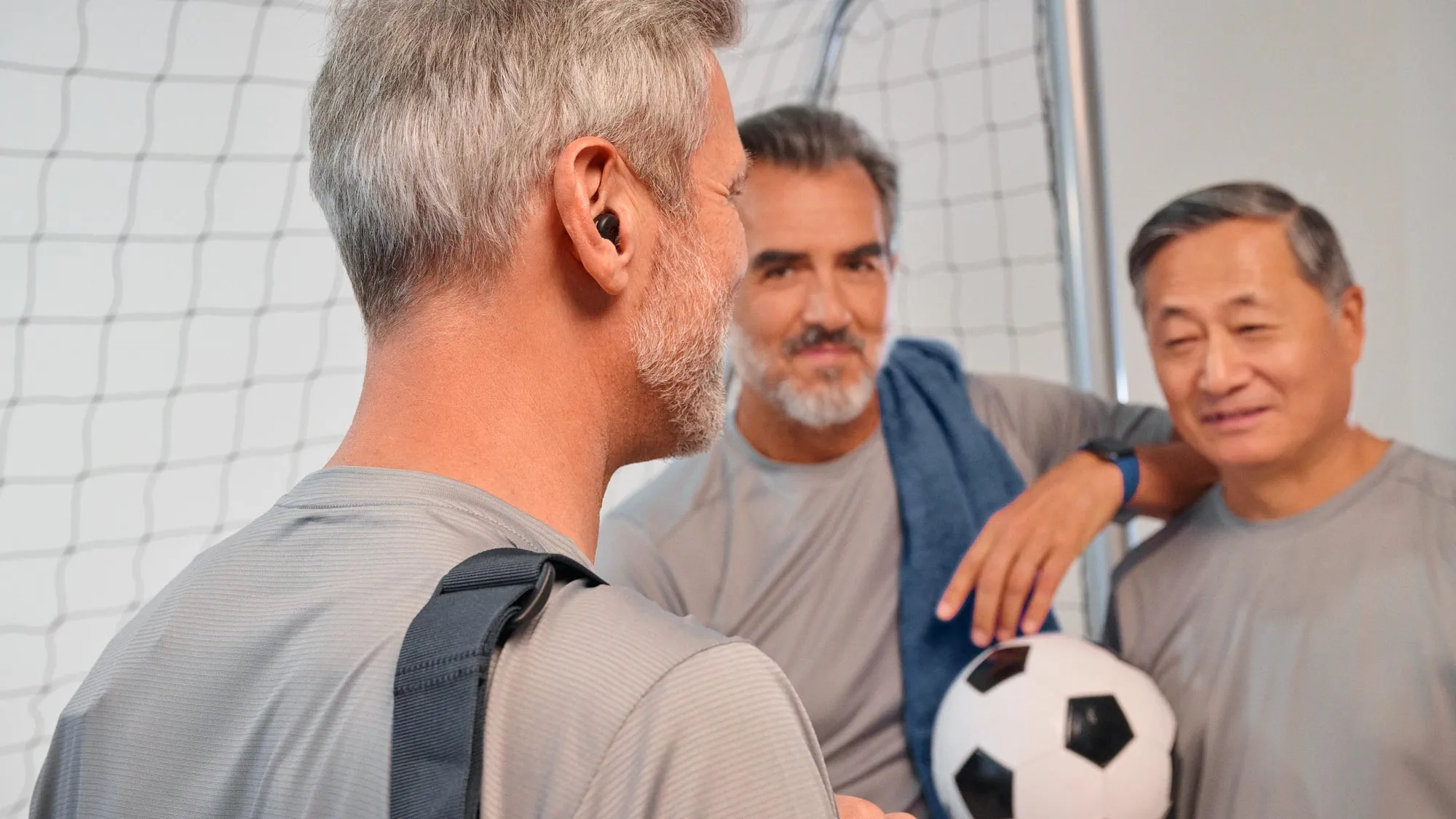 Man playing football wearing Signia Active hearing aids