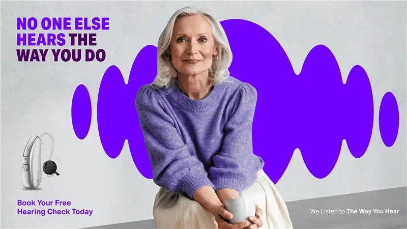 Woman showing Signia IX hearing aids in hand truly showing the small size.
